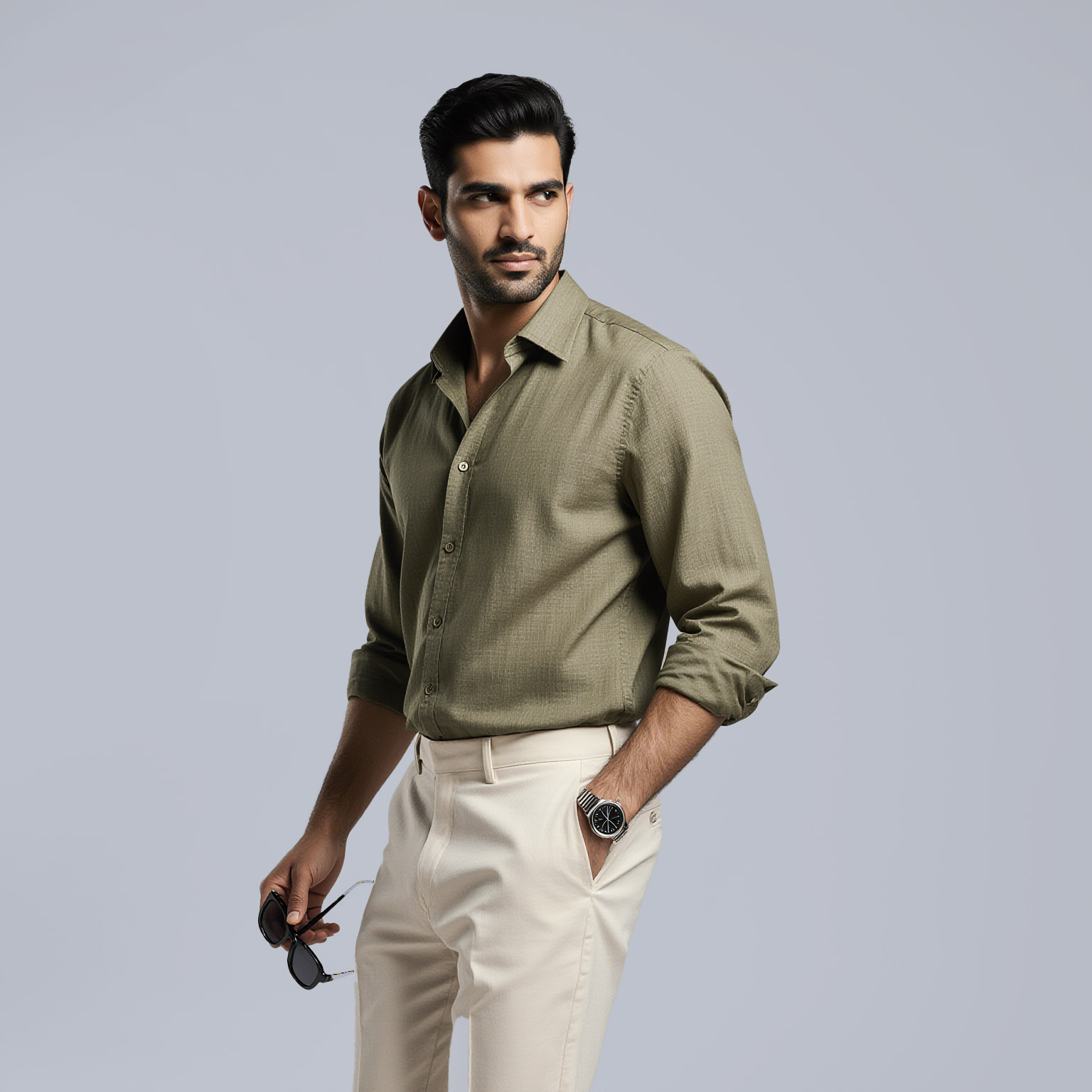 Man wearing olive button-down shirt and light trousers near Fisher Island dry cleaner